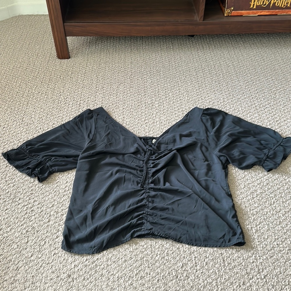 Black, puff-sleeved blouse with drawstring in the middle